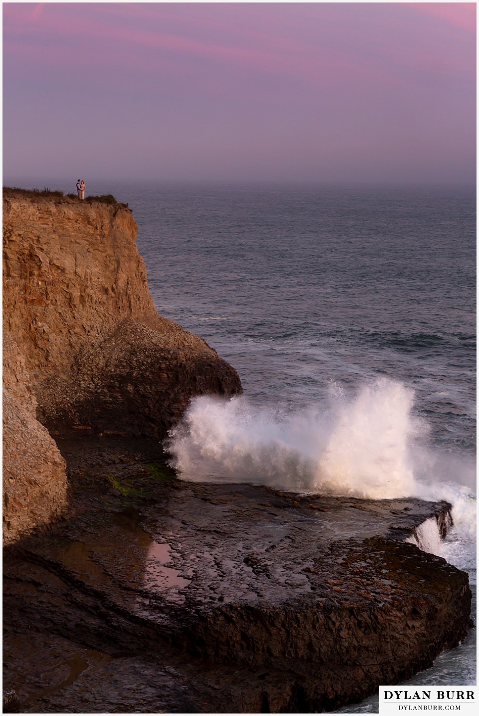 santa cruz california elopement wedding adventure bride and groom on top of cliffs as giant waves roll in