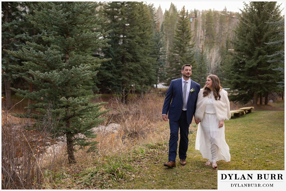 sonnenalp vail wedding bride and groom walking along creek