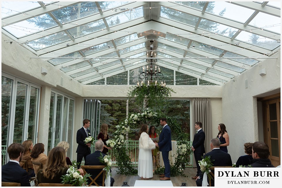 sonnenalp vail wedding bride and groom and guests in sunroom terrace