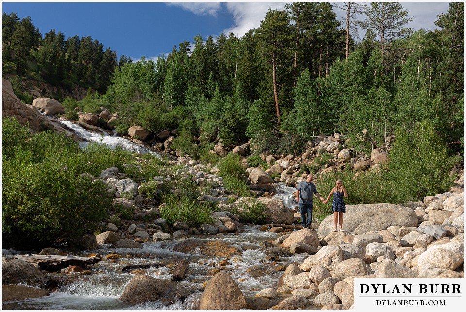 spring engagement photo session in the mountains walking alongside river