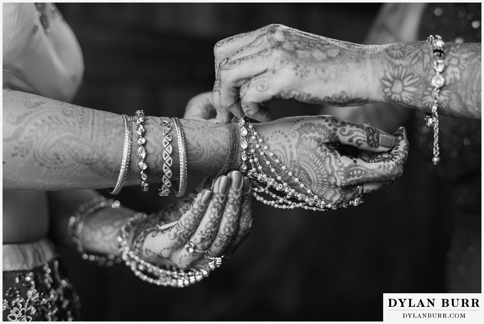 spruce mountain ranch wedding indian wedding black and white bride and her mother putting on jewlery