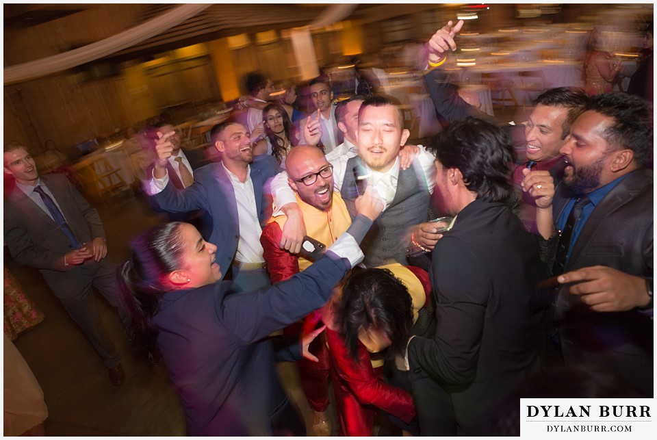 spruce mountain ranch wedding indian wedding groomsmen singing together at reception