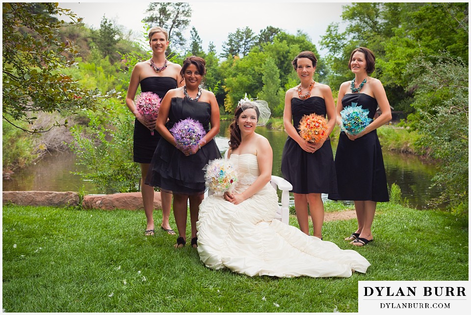 stone mountain lodge wedding bride in chair with bridesmaids around her near lake