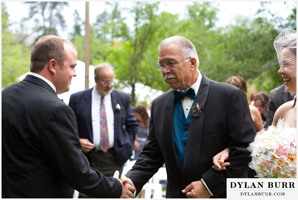 stone mountain lodge wedding father shaking hands with groom