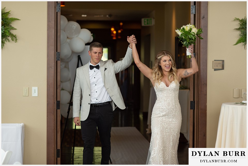 bride and groom entering reception