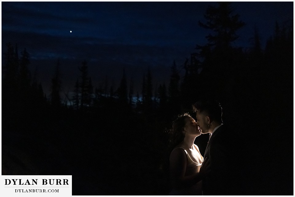 sunrise hike elopement to dream lake a kiss in the forest at sun before sunrise