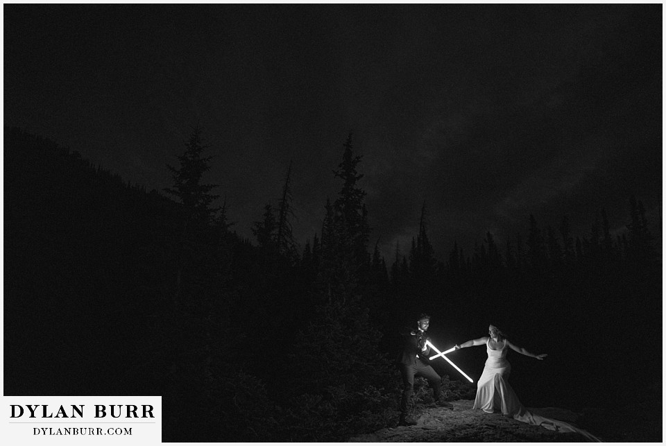 sunrise hike elopement to dream lake black and white of lightsaber battle in mountains at night