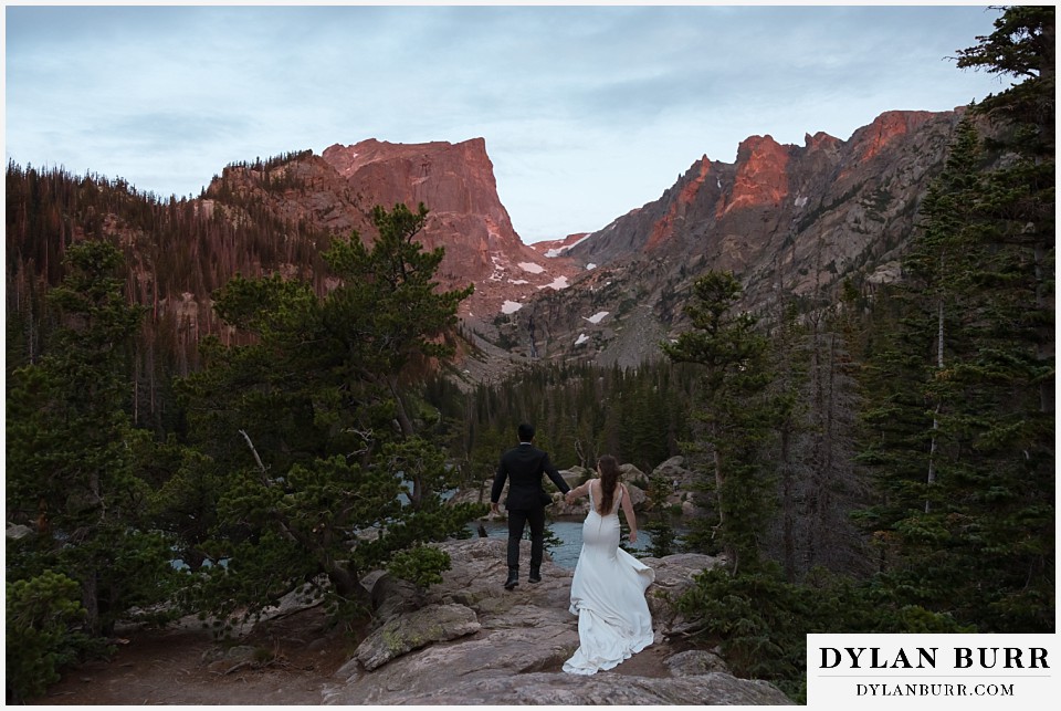 sunrise hike elopement to dream lake sunrise colors hitting mountains