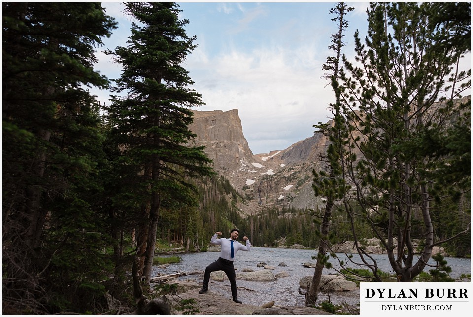 sunrise hike elopement to dream lake groom flexing