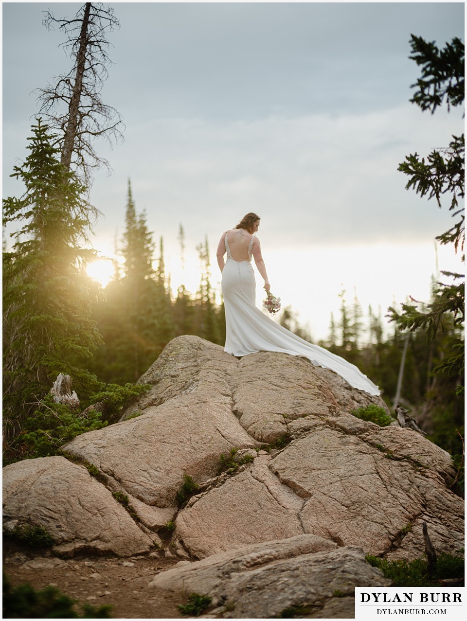 sunrise hike elopement to dream lake sunrise glow on bride showing train on dress