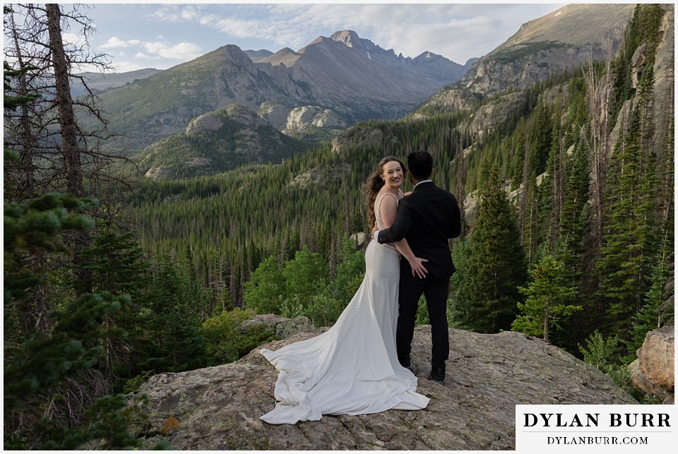 sunrise hike elopement to dream lake bride grabbing the grooms butt