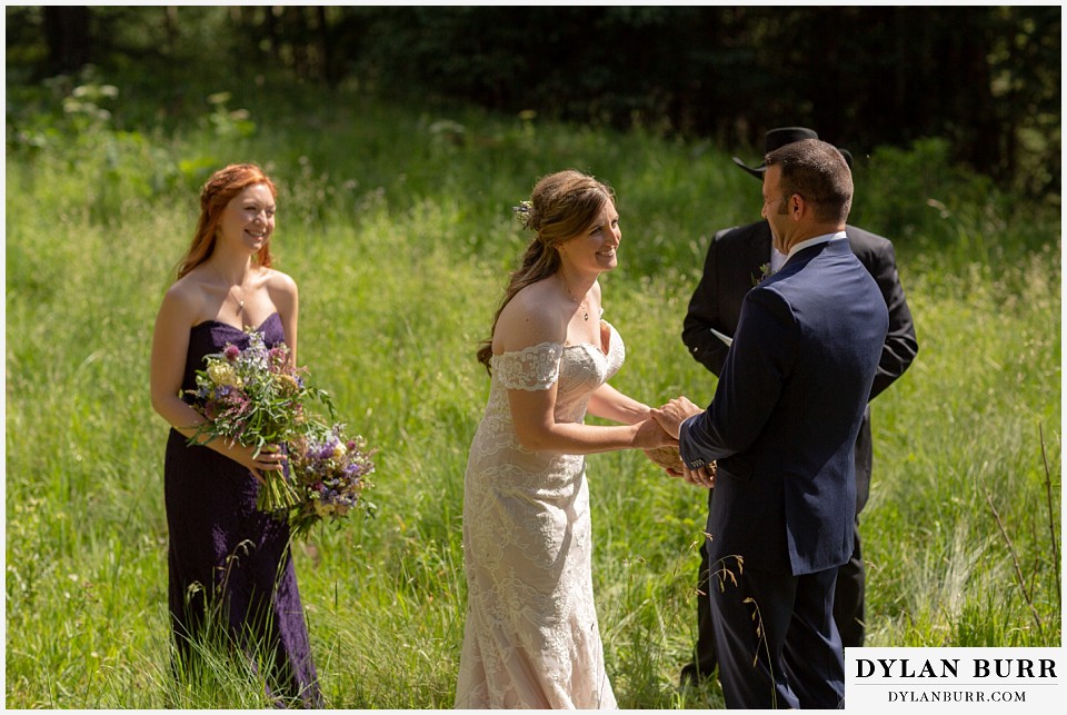 telluride colorado elopement wedding adventure bride and groom holding wedding stone oathing