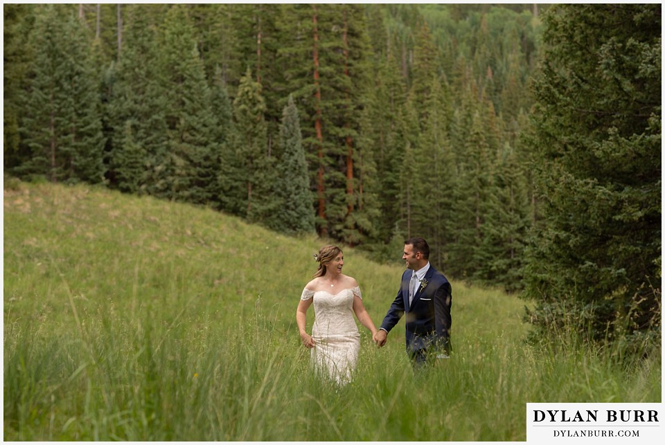 telluride colorado elopement wedding adventure bride and groom walking together in field
