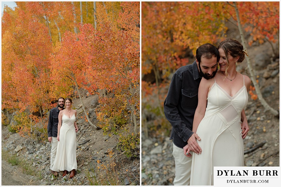 telluride trout lake elopement wedding couple together in deep orange and red aspen leaves