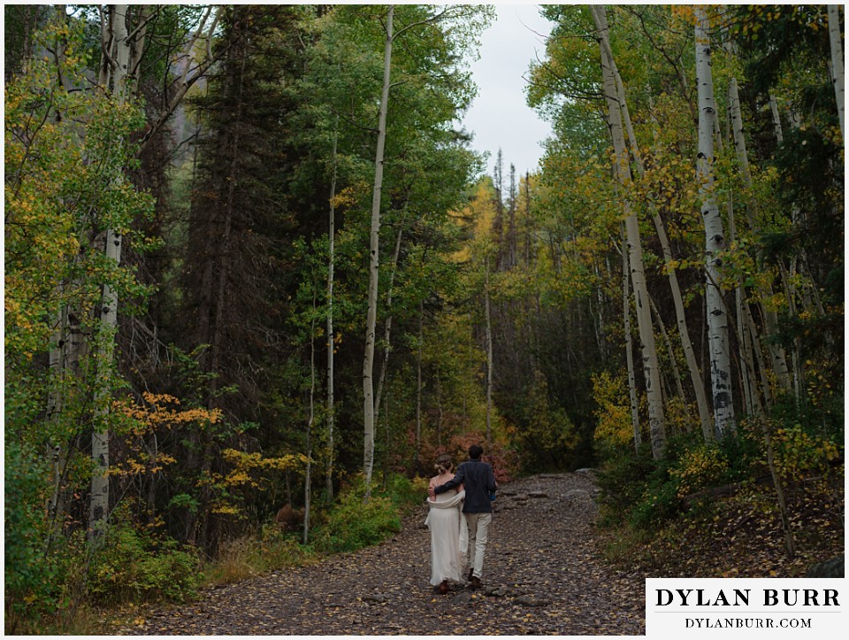 telluride elopement wedding walking together into the forest