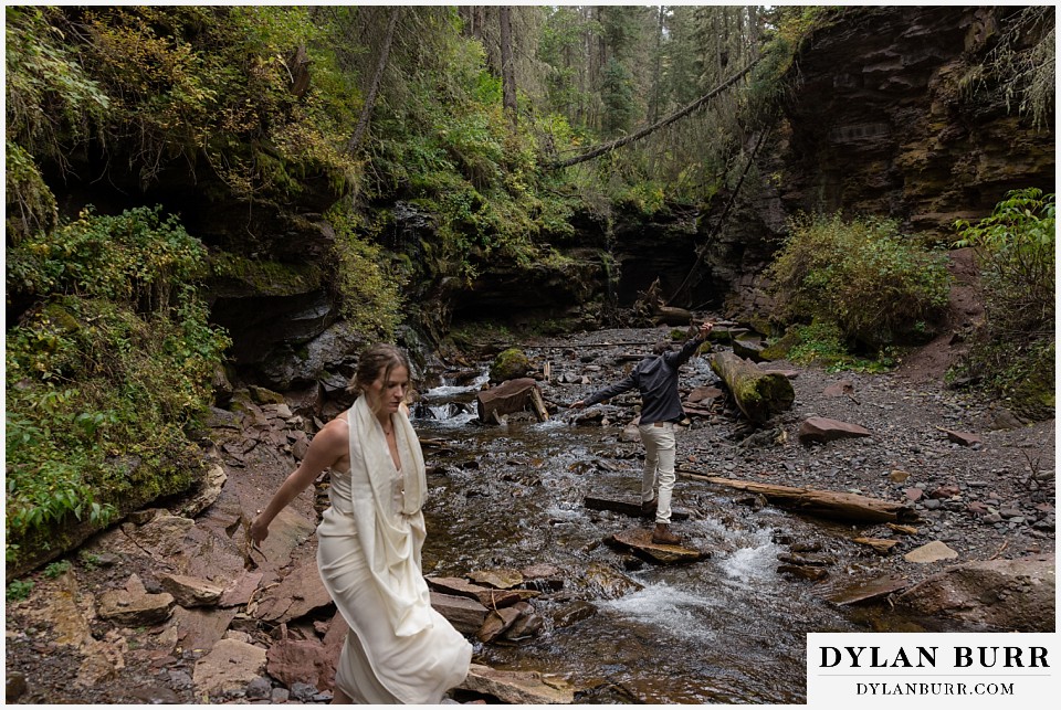 telluride elopement wedding bride and groom navigating a river crossing