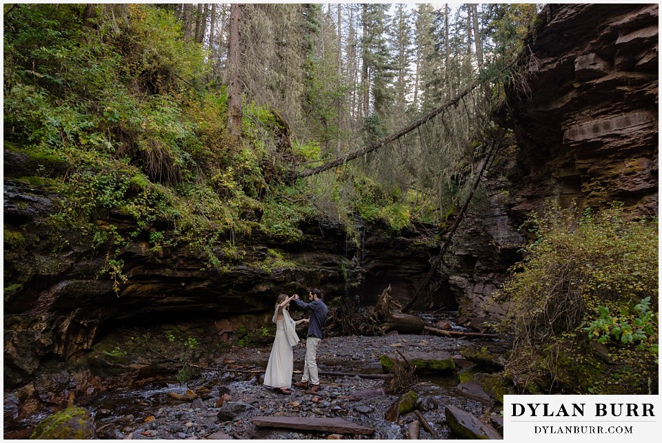 telluride elopement wedding first dance together at the base of a river