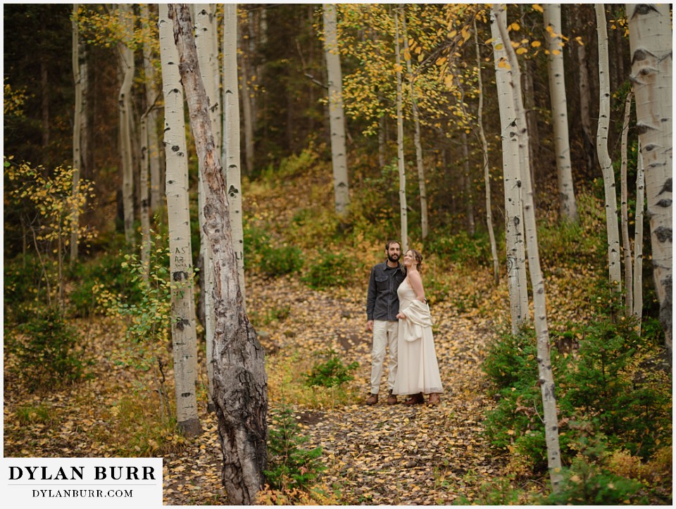 telluride elopement wedding couple standing together in an aspen forest like it was a yellow brick road