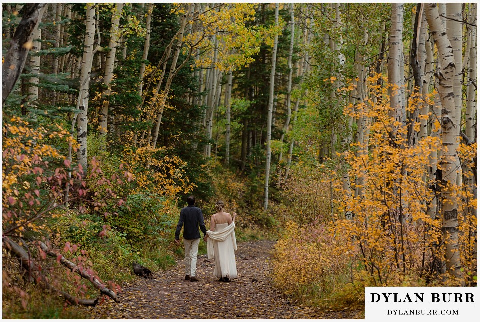telluride elopement wedding couple hiking down the trail together