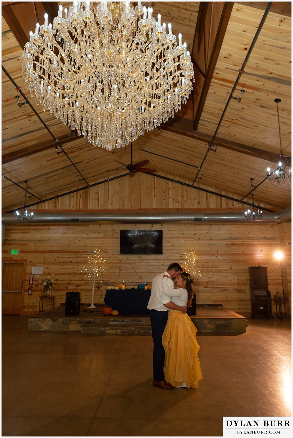 the covey fort collins wedding venue first dance during reception with giant chandelier