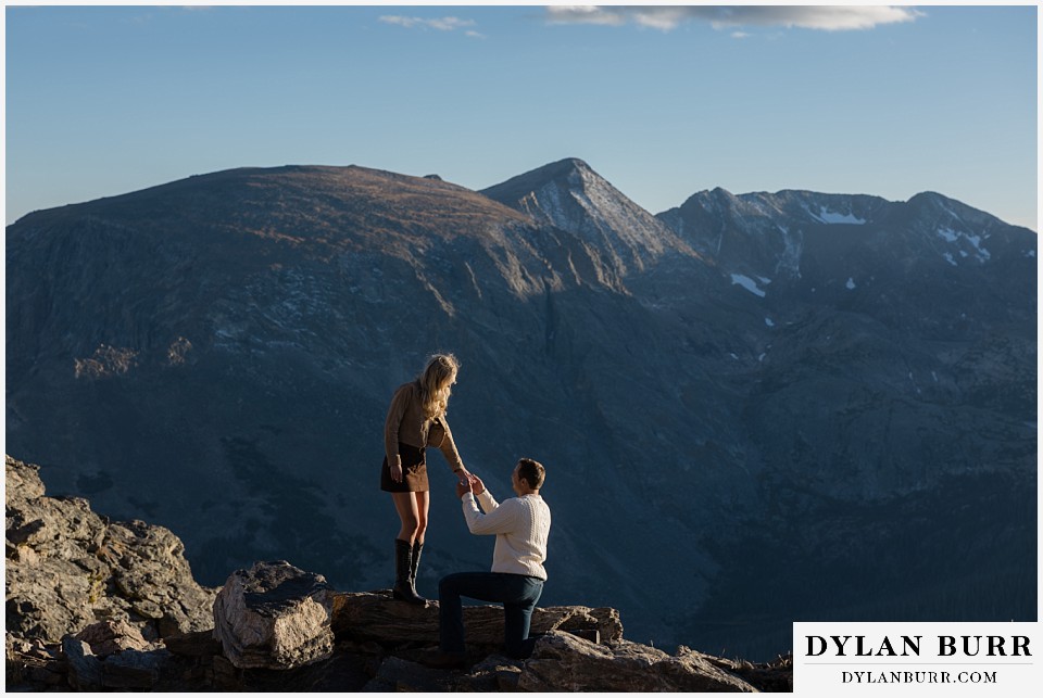 trail ridge road marriage proposal kneeling with giant mountains