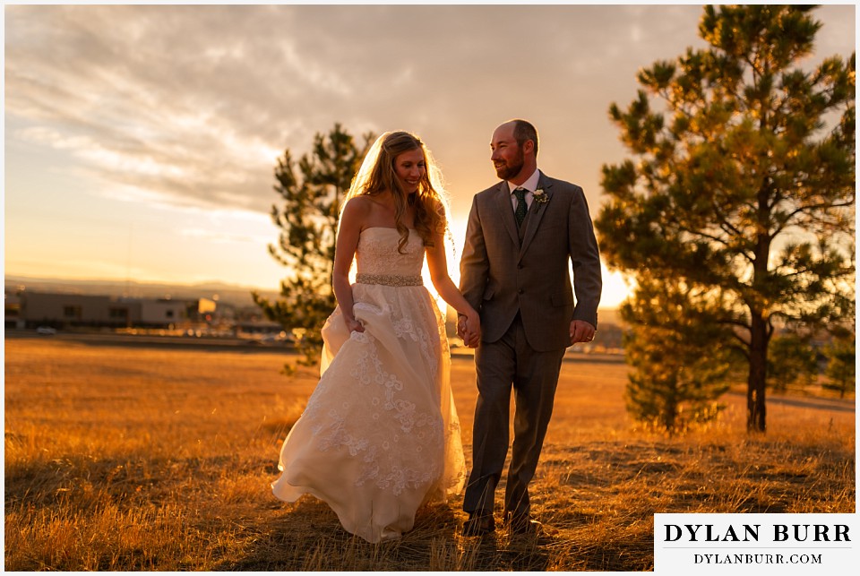 villa parker wedding parker colorado bride and groom holding hands walking together