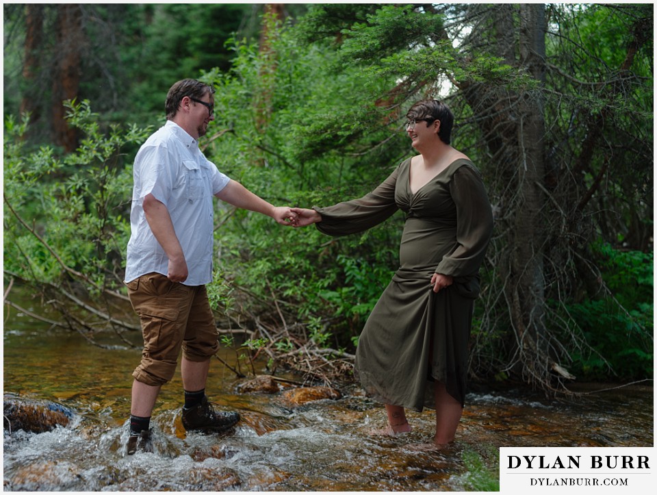water engagement session rocky mountain national park dancing together in the water