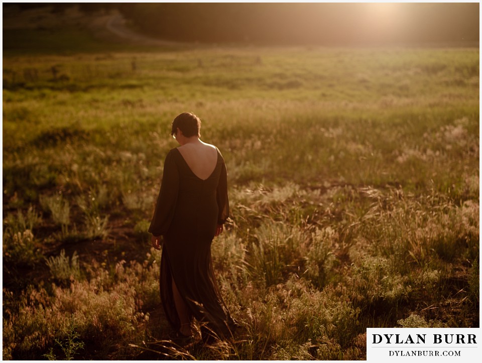 water engagement session rocky mountain national park walking in an open field at sunset moraine valley