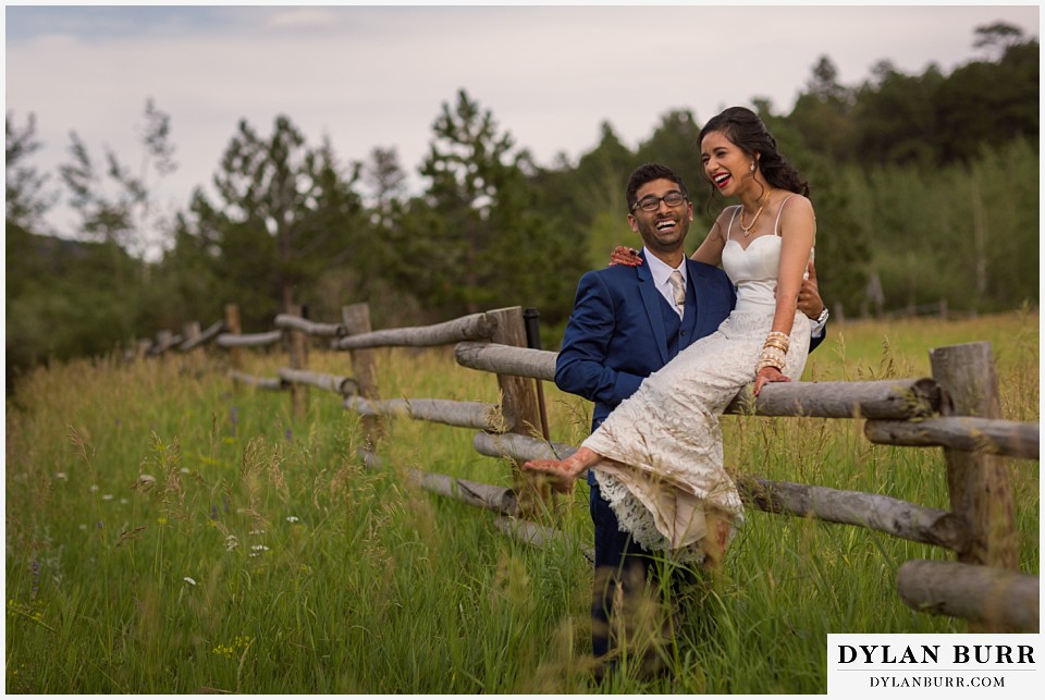 wild basin lodge hindu wedding couple sitting on fence