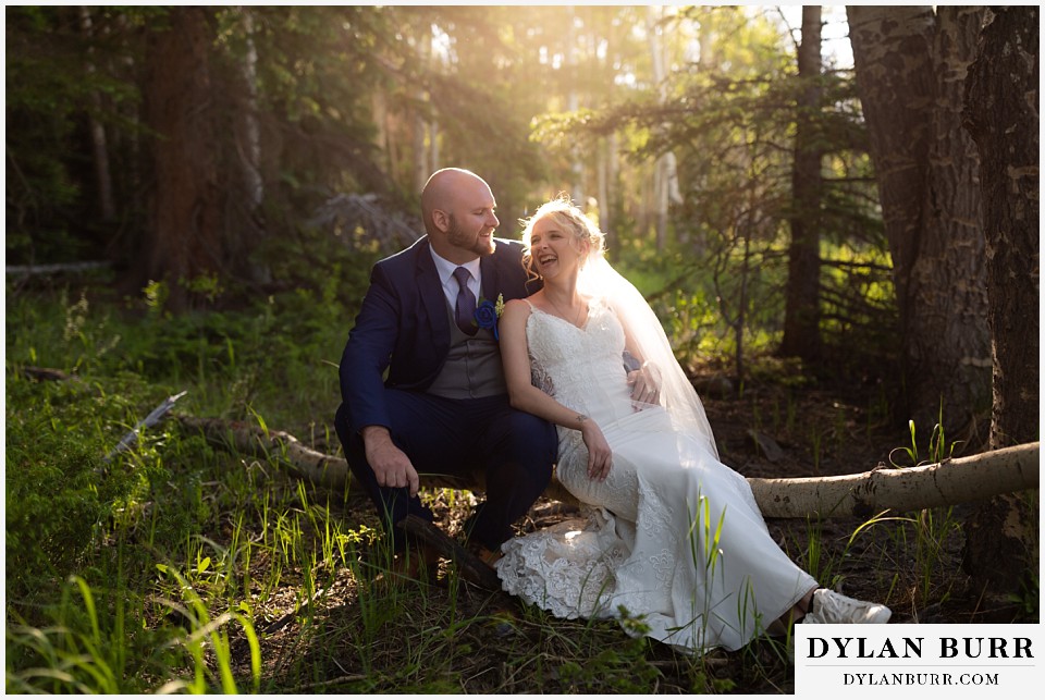 mountain wedding bride and groom laughing together in the trees