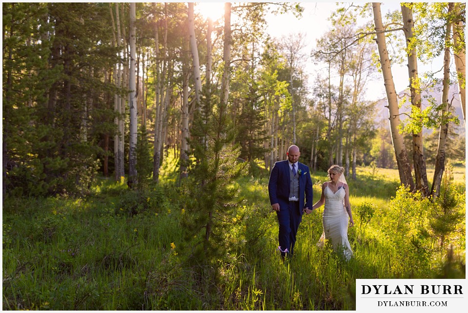 rocky mountain wedding bride and groom walking together in mountains