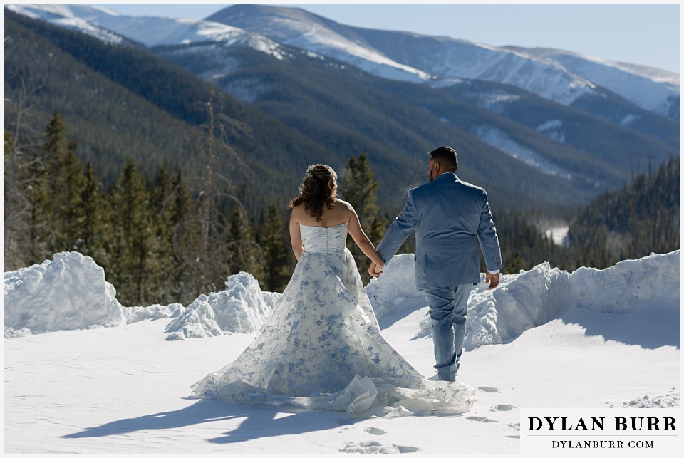 winter elopement wedding near winter park colorado walking on the snowy mountaintop