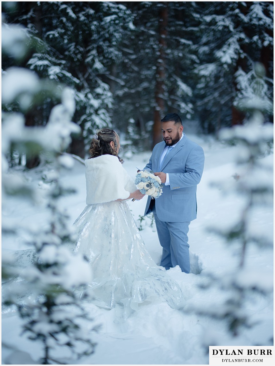 winter elopement wedding near winter park colorado groom reading vows to eachother