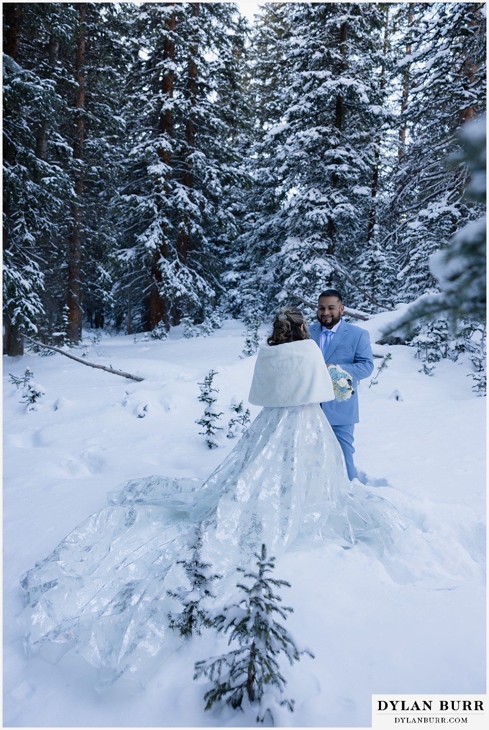winter elopement wedding near winter park colorado brides shimmery dress in the fluffy snow