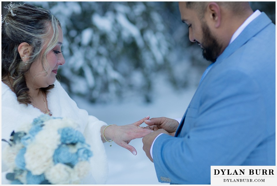winter elopement wedding near winter park colorado exchanging rings