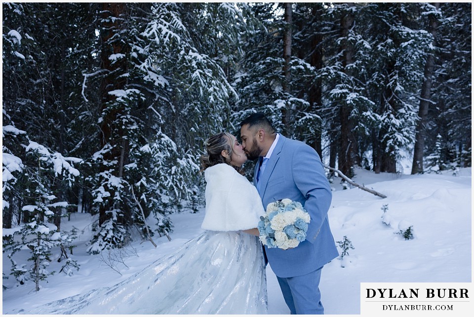 winter elopement wedding near winter park colorado first kiss
