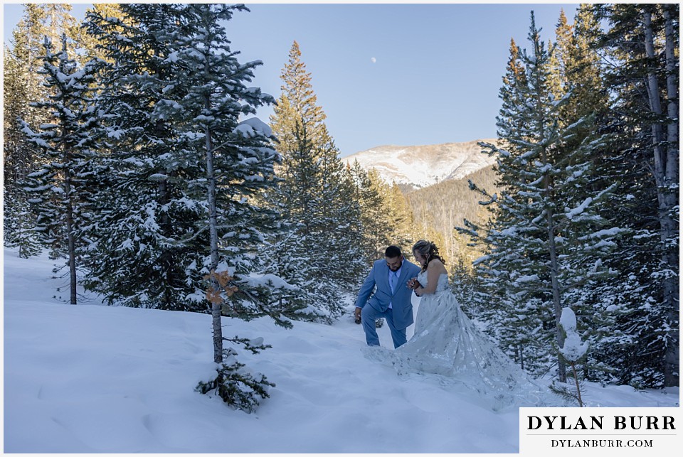 winter elopement wedding near winter park colorado walking in deep snow