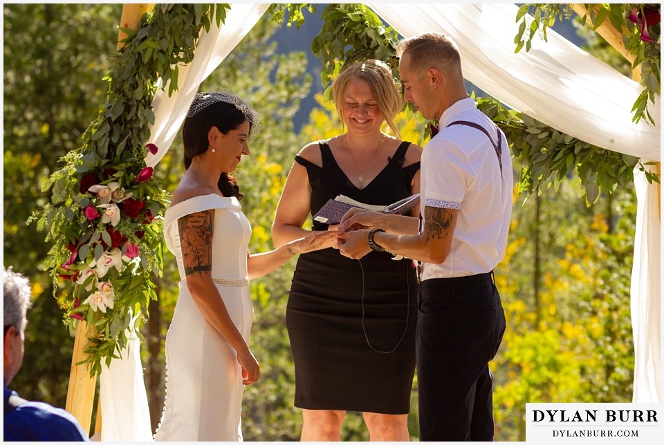 winter park mountain lodge wedding colorado groom putting on bride's ring