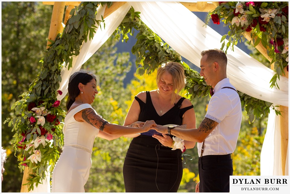 winter park mountain lodge wedding colorado bride putting on grooms ring
