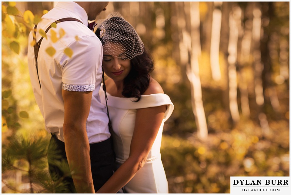 winter park mountain lodge wedding colorado bride relaxed against grooms chest