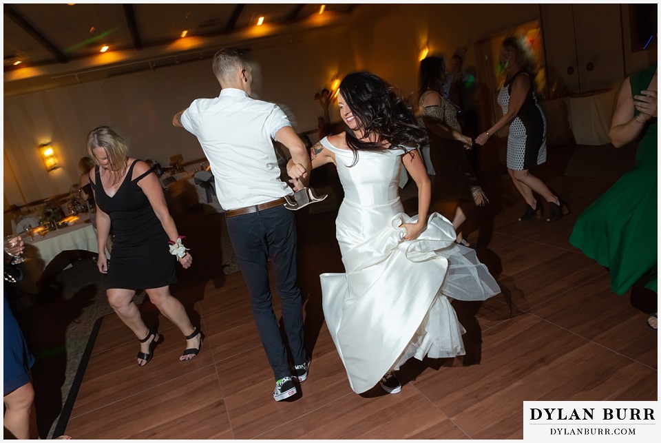 winter park mountain lodge wedding colorado bride and groom swinging on each other on the dance floor