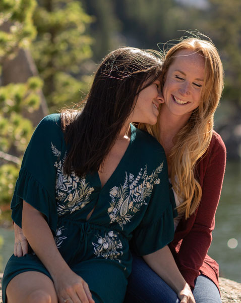 couple having so much fun in mountains and trusting in me their photographer to get them there