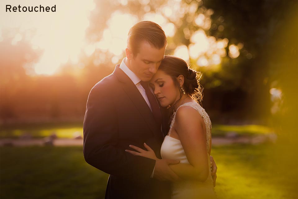 newlywed couple standing together in glowing light at sunset