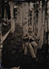 tintype wet plate of an elderly woman sitting in the trees in the colorado mountains